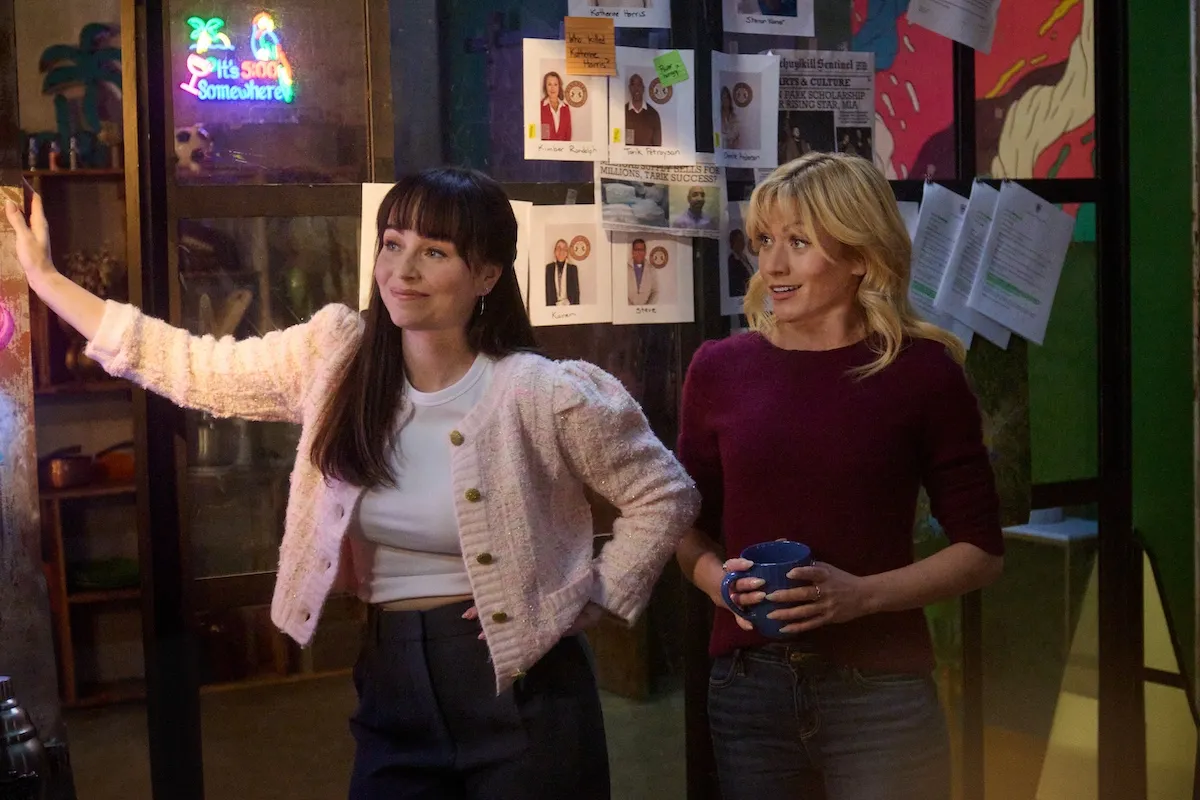 Woman in a pink cardigan standing next to a blonde woman in 'True Justice: An Eye for and Eye