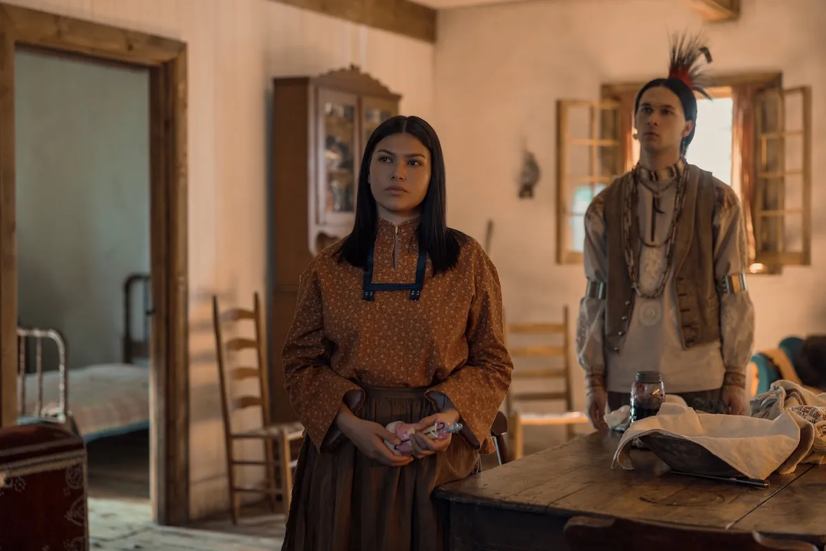White Sun and Little Puma standing in a room in Netflix's 'Little House on the Prairie'
